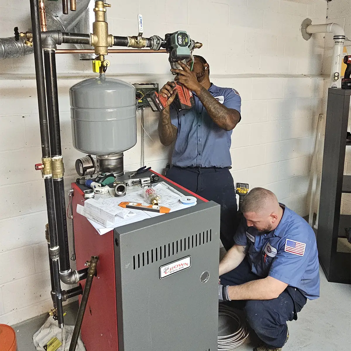 two Meyer & Depew technicians repairing a boiler in a NJ home