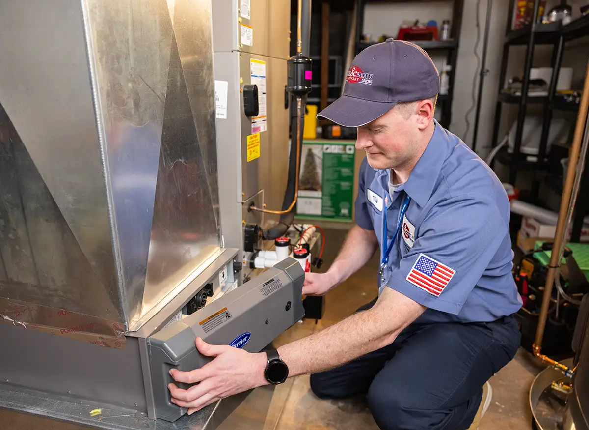 A photo of a Meyer & Depew technician, working on a heating system.