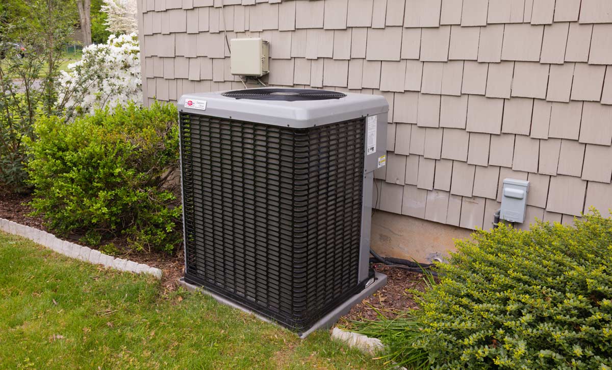 An air conditioner unit outside of a house.