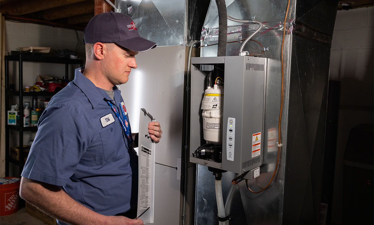 A technician servicing a humidifier.
